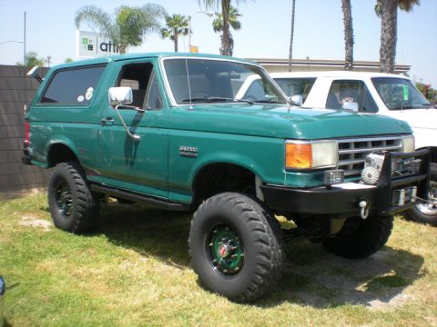 1979 Ford Bronco - This modified Ford Bronco is shown from a three-quarter front angle, parked outdoors on a sunny day.