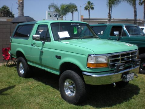 1979 Ford Bronco - This SUV features a bright green paint job, chrome wheels, and KC auxiliary lights on the front bumper.