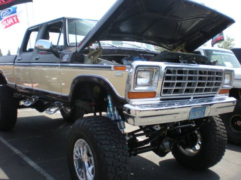 1979 Ford Bronco - This lifted 1979 Ford F-150 pickup truck features a two-tone paint scheme and a prominent chrome grille.
