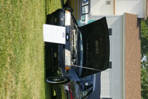 1992 Ford Taurus - A black 1992 Ford Taurus SHO is displayed with its hood open, revealing the engine bay.
