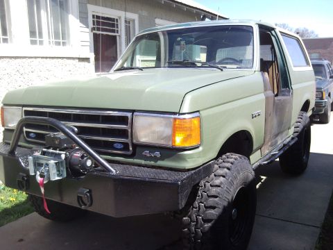 1989 Ford Bronco - This 1989 Ford Bronco features a heavy-duty bumper and winch, ready for off-road adventures.