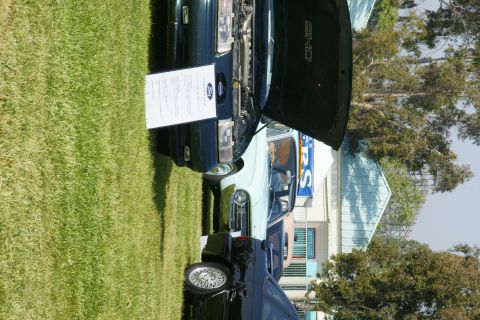 1992 Ford Taurus - A 1992 Ford Taurus SHO is displayed with its hood open at an outdoor event.