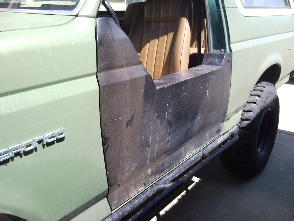 1989 Ford Bronco side view with custom doors and tan interior