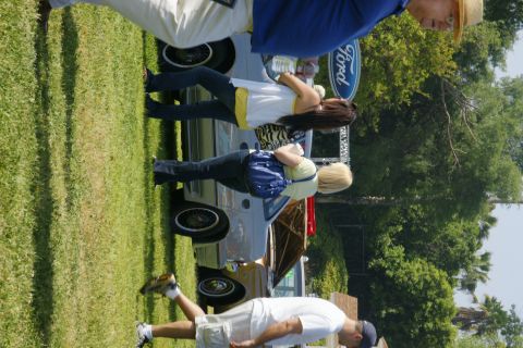 1992 Ford Taurus - People gathered around a 1992 Ford Taurus at an outdoor car show.