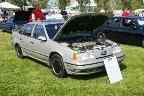 1992 Ford Taurus - Silver 1992 Ford Taurus on display at a car show, hood open to reveal the engine.