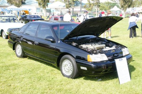 1992 Ford Taurus - Black 1992 Ford Taurus on display at a car show with its hood open.
