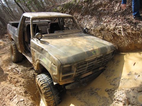 1993 Ford Bronco - This heavily modified 1980 Ford Bronco is stuck deep in mud on an off-road trail.