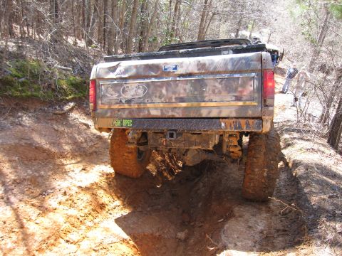 1993 Ford Bronco - This heavily modified Ford Bronco navigates a muddy off-road path.