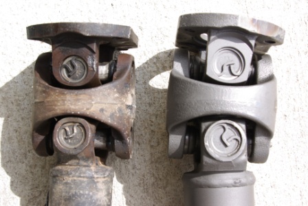 1995 Ford Bronco - Comparison of a worn u-joint with a freshly replaced one, showing the difference in condition and finish.