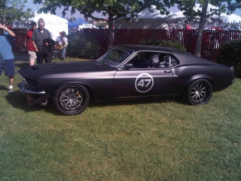 1986 Ford Bronco - Matte black 1969 Ford Mustang with racing number 47 on the side.