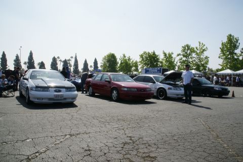 1992 Ford Taurus - Several Ford Taurus models are displayed at an outdoor car show event.