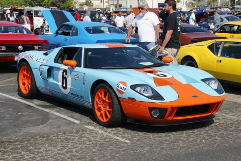 1992 Ford Taurus - A light blue and orange Ford GT with racing livery is parked at a car show.