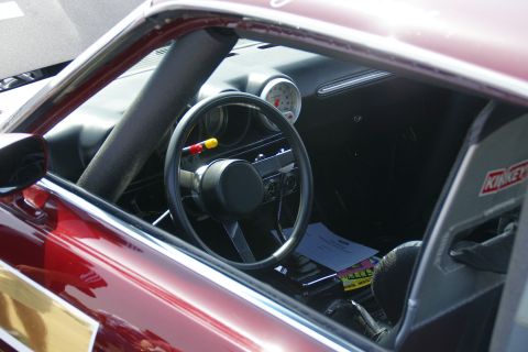 1992 Ford Taurus - Interior view of a modified car, showing a racing seat and aftermarket steering wheel.
