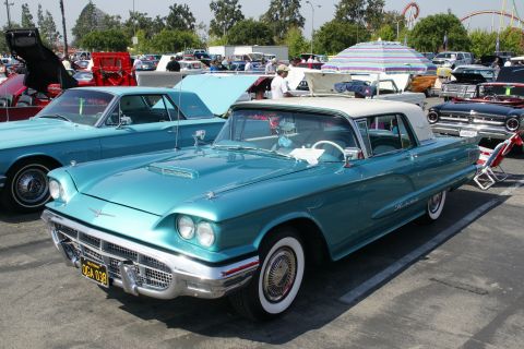 1992 Ford Taurus - A teal 1958 Ford Thunderbird convertible is parked at a car show, with other classic cars visible in the background.
