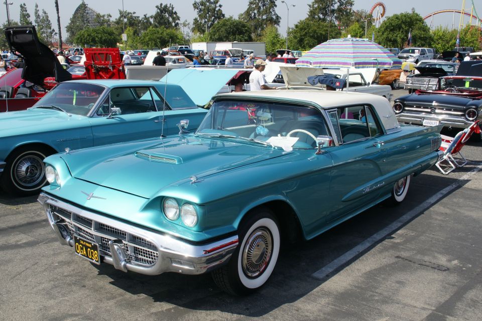 Teal 1958 Ford Thunderbird convertible with white roof and whitewall tires