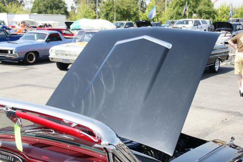 1992 Ford Taurus - A car show features multiple vehicles with hoods open, displaying their engines and classic designs.