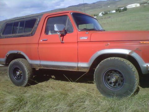 1978 Ford Bronco - Side view of a red 1978 Ford Bronco with aftermarket wheels.