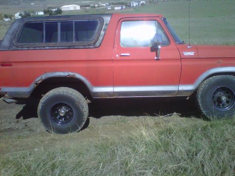 1978 Ford Bronco - This 1978 Ford Bronco is shown from the side, a red exterior and black hardtop.