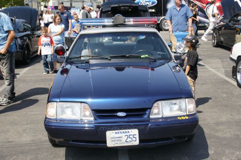 1992 Ford Taurus - A Nevada Highway Patrol car is parked at an outdoor car show with spectators around.