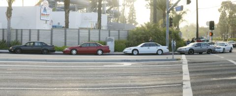 1992 Ford Taurus - A 1992 Ford Taurus is seen parked on the side of the road alongside other vehicles.