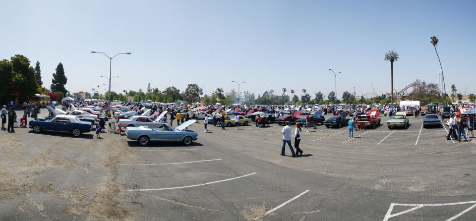 Outdoor car show with dozens of classic cars parked in rows under a clear sky