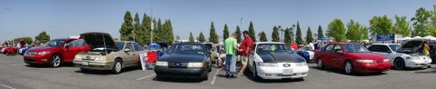 1992 Ford Taurus - A gathering of Ford Taurus vehicles, with several models on display under a clear sky.
