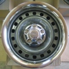 1976 Ford Torino - Close-up of a vehicle wheel, chrome trim and a central hub with lug nuts.