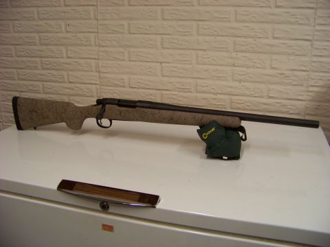 1995 Mercury Grand Marquis - A rifle is shown on a white surface in front of a brick wall.