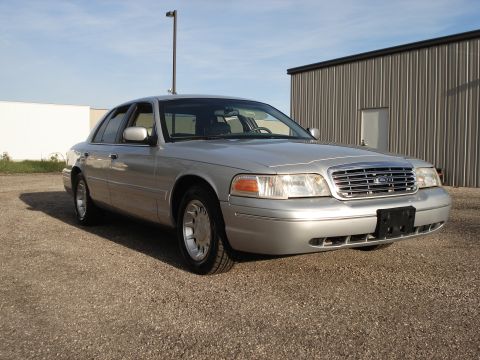 2000 Ford Crown Victoria - This silver 2000 Ford Crown Victoria is shown from a 3/4 front angle, parked outdoors.