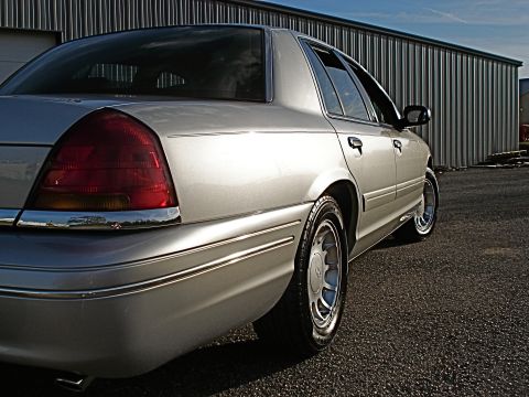 2000 Ford Crown Victoria - Rear quarter view of a silver 2000 Ford Crown Victoria parked outdoors.