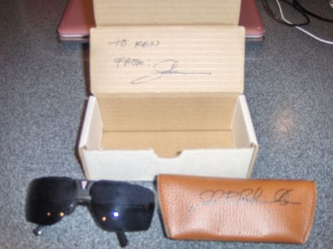 1977 Pontiac Trans Am - Sunglasses and a gift box with handwritten 'TO: KEN FROM: John' are on a textured surface.