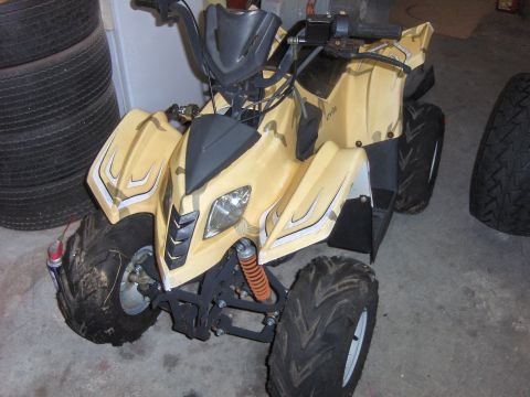 1977 Pontiac Trans Am - ATV with yellow and camouflage body panels and knobby tires.
