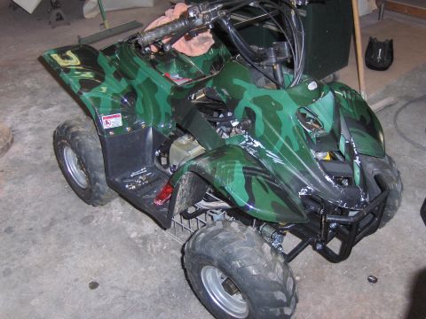 1977 Pontiac Trans Am - This ATV has a green and black camouflage pattern and appears to be in a garage or workshop.