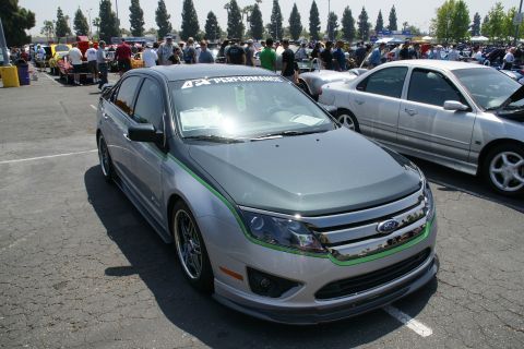 1992 Ford Taurus - This modified sedan features a two-tone paint scheme with green accents and a performance decal on the windshield.