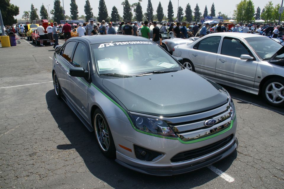 Silver and grey sedan with green racing stripes and '4 Performance' windshield banner