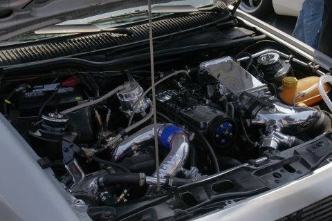1992 Ford Taurus - Customized engine bay polished chrome components and aftermarket air intake system.