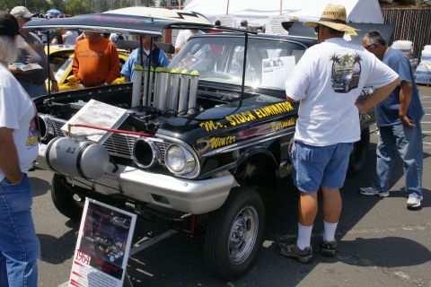 1992 Ford Taurus - A modified drag car, likely a 1964 model, is displayed with its hood open and engine exposed.
