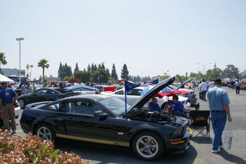 1992 Ford Taurus - A black 2007 Ford Mustang Shelby GT-H is displayed with its hood open at a car show.