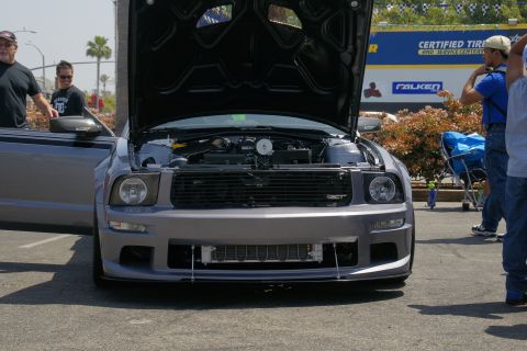 1992 Ford Taurus - Gray Ford Mustang with hood open, displaying its engine and intercooler. The car is parked outdoors.