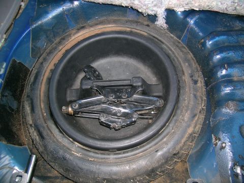 1995 Ford Probe - Spare tire well with jack and tire visible in the trunk.