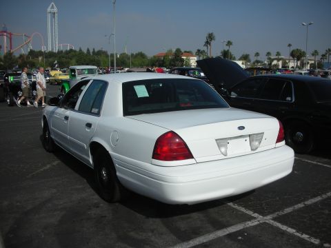2004 Ford Crown Victoria - A white 2004 Ford Crown Victoria is seen from the rear at a car show held at Knott's Berry Farm.