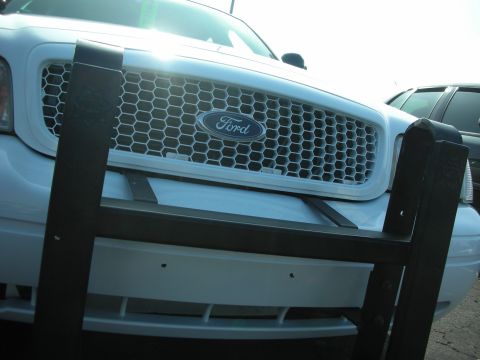 2004 Ford Crown Victoria - Front view of a 2004 Ford Crown Victoria showing its grille and a protective push bar.