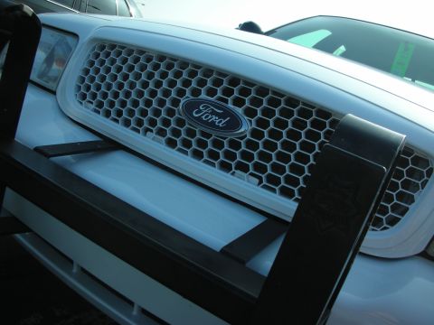 2004 Ford Crown Victoria - Close-up of a Ford Crown Victoria's honeycomb grille and front push bar.