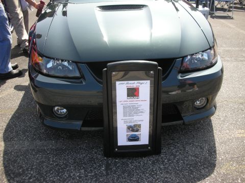 2004 Ford Crown Victoria - A 2009 Roush Stage 2 Mustang is displayed with its specifications on a sign in front of the vehicle.