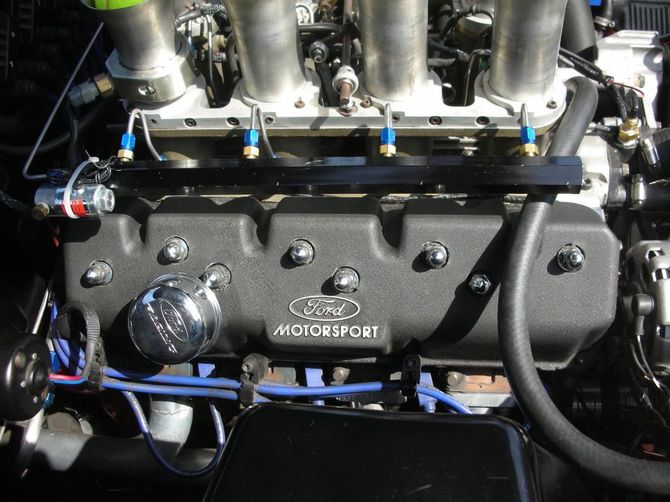 Close-up of a Ford Motorsport engine with chrome oil cap and fuel injectors