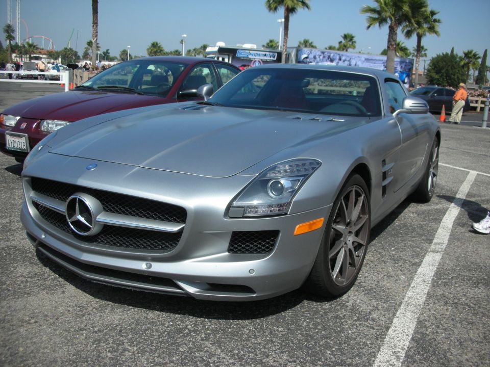 Silver Mercedes-Benz SLS AMG parked next to a maroon Saturn Ion