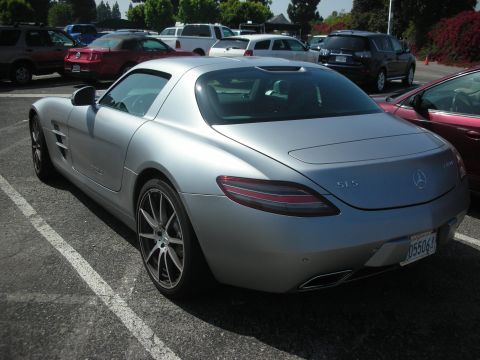 2004 Ford Crown Victoria - A silver Mercedes-Benz SLS AMG is parked in a lot with other vehicles.