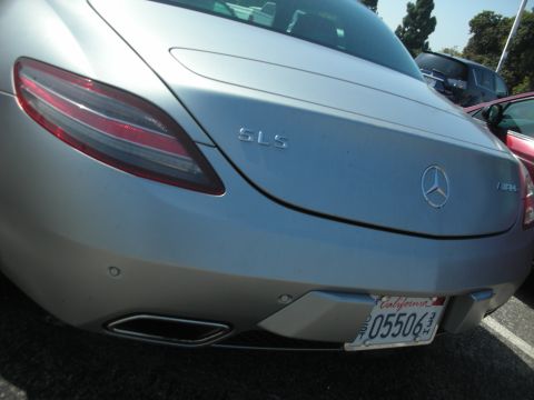 2004 Ford Crown Victoria - A silver Mercedes-Benz SLS AMG is parked, showing its rear end and a California license plate.