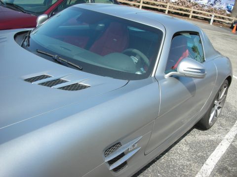 2004 Ford Crown Victoria - Silver coupe with red interior and distinctive side vents.
