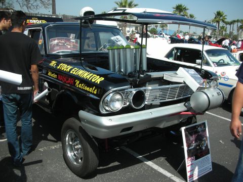 2004 Ford Crown Victoria - A customized vehicle, labeled 'Mr. Stock Eliminator', is displayed with its hood open, its engine and modifications.